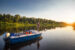 a man fly fishes from a small boat in a lake at Rocks State Park in MD.