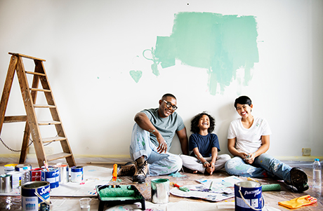 A family paints a wall after getting a personal loan.