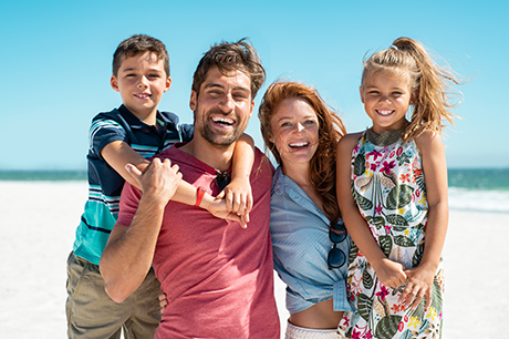 A family enjoys a beach vacation financed through a personal loan.