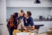 a Mom and Dad snuggle with a child after balancing their checking account.