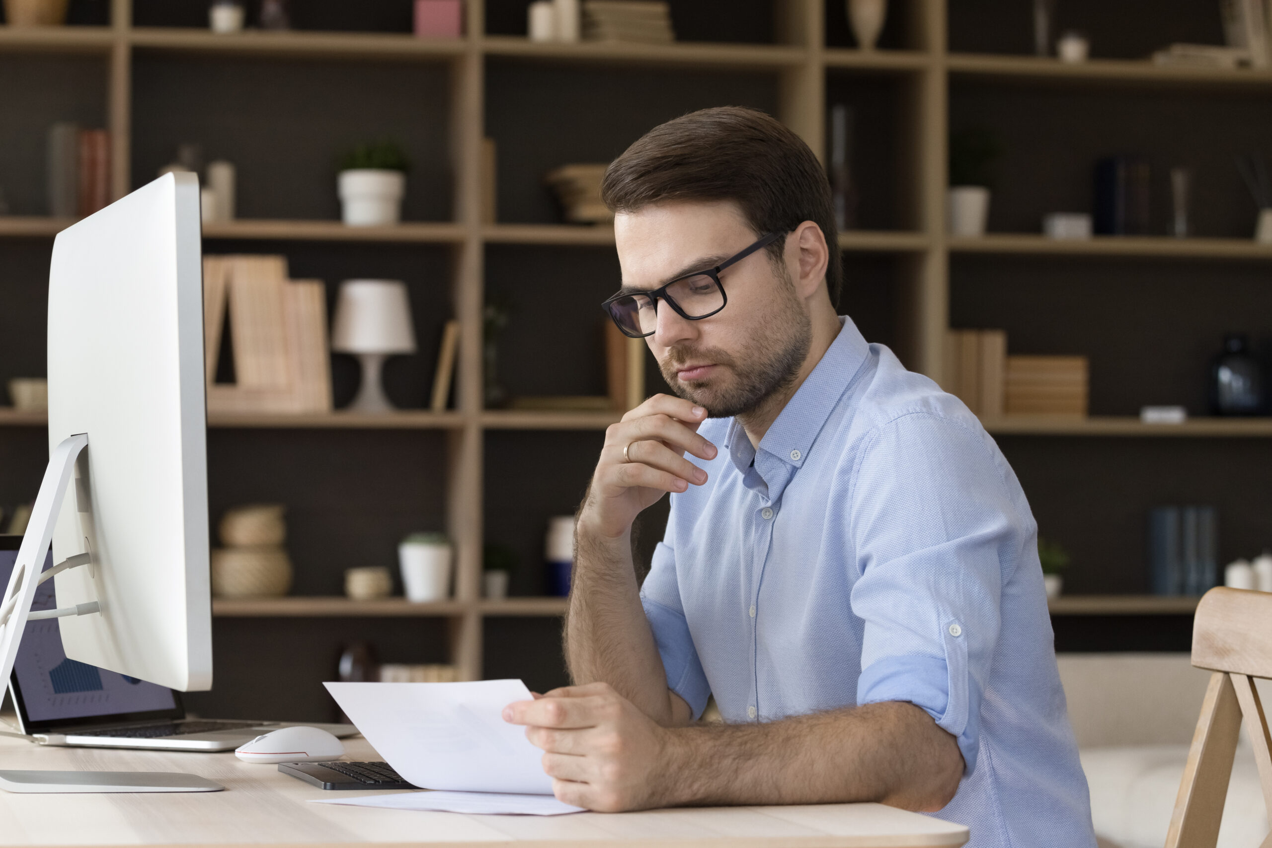 A young man reviews what documents are needed for a personal loan.