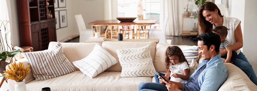 Family, parents and daughter, on couch in house