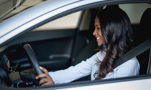 Young female test driving car