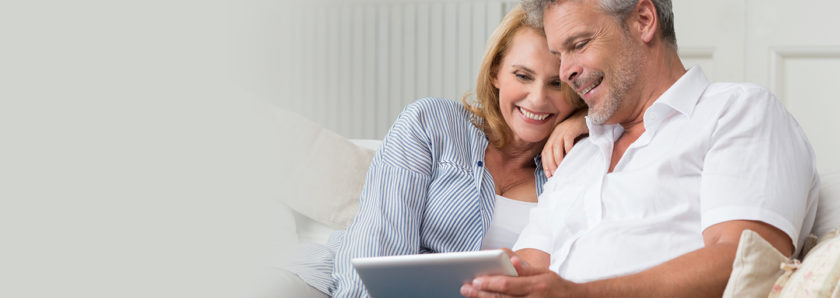 Couple checking finances on tablet