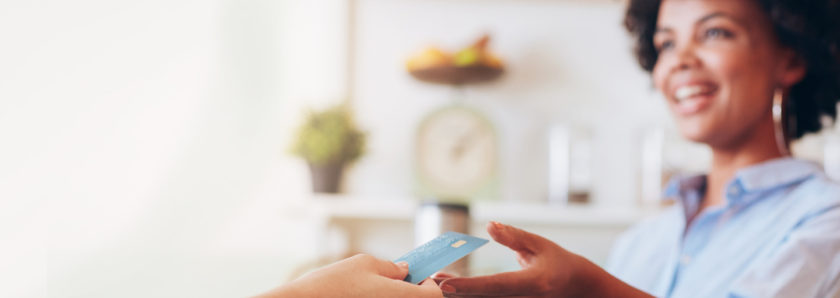 Friendly cashier accepting card payment