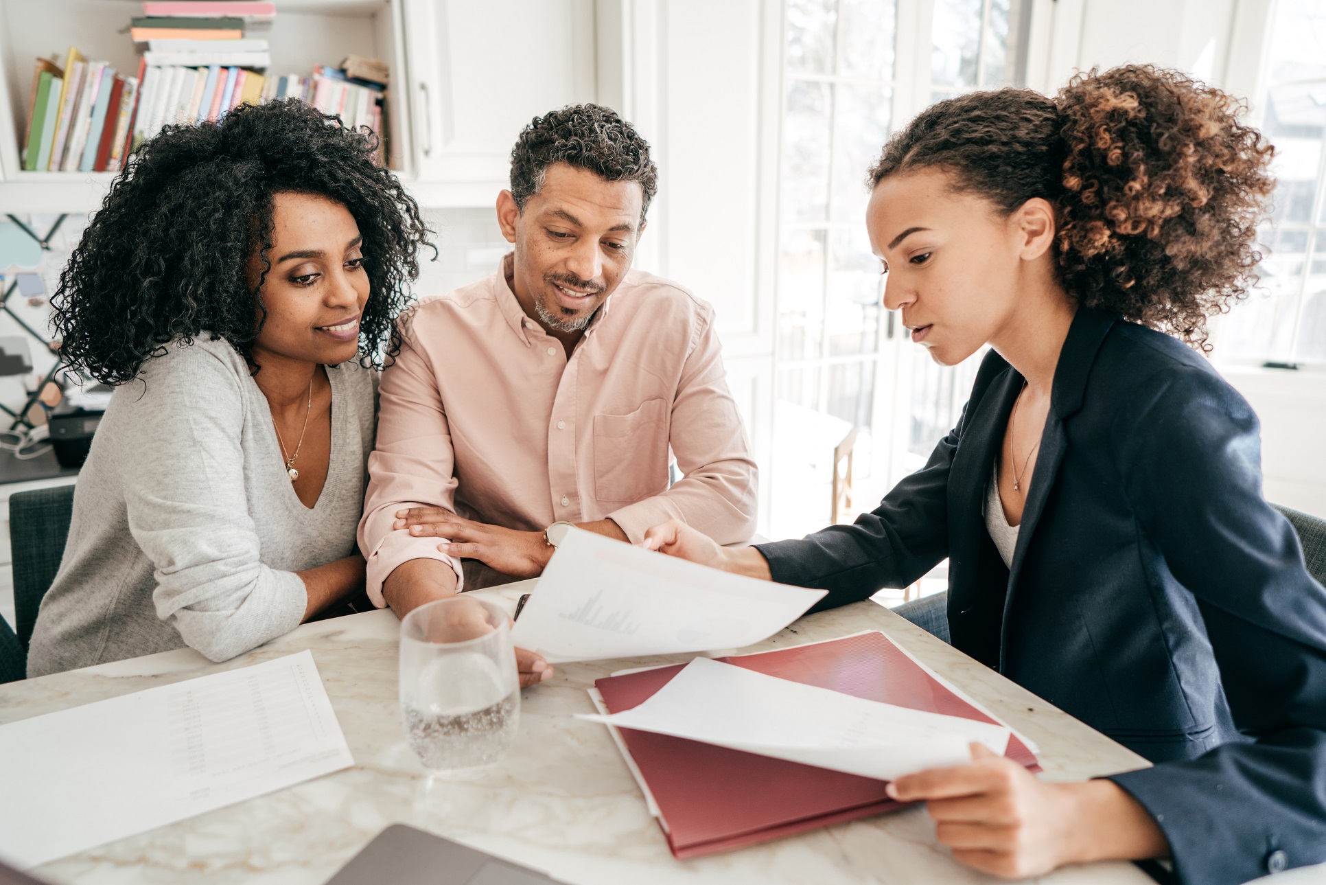 Couple reviewing finances with planner