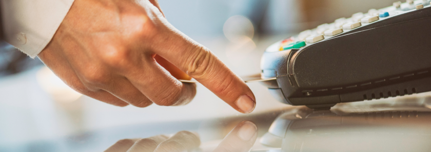 Hand inserting AFFCU Debit Card into emv terminal