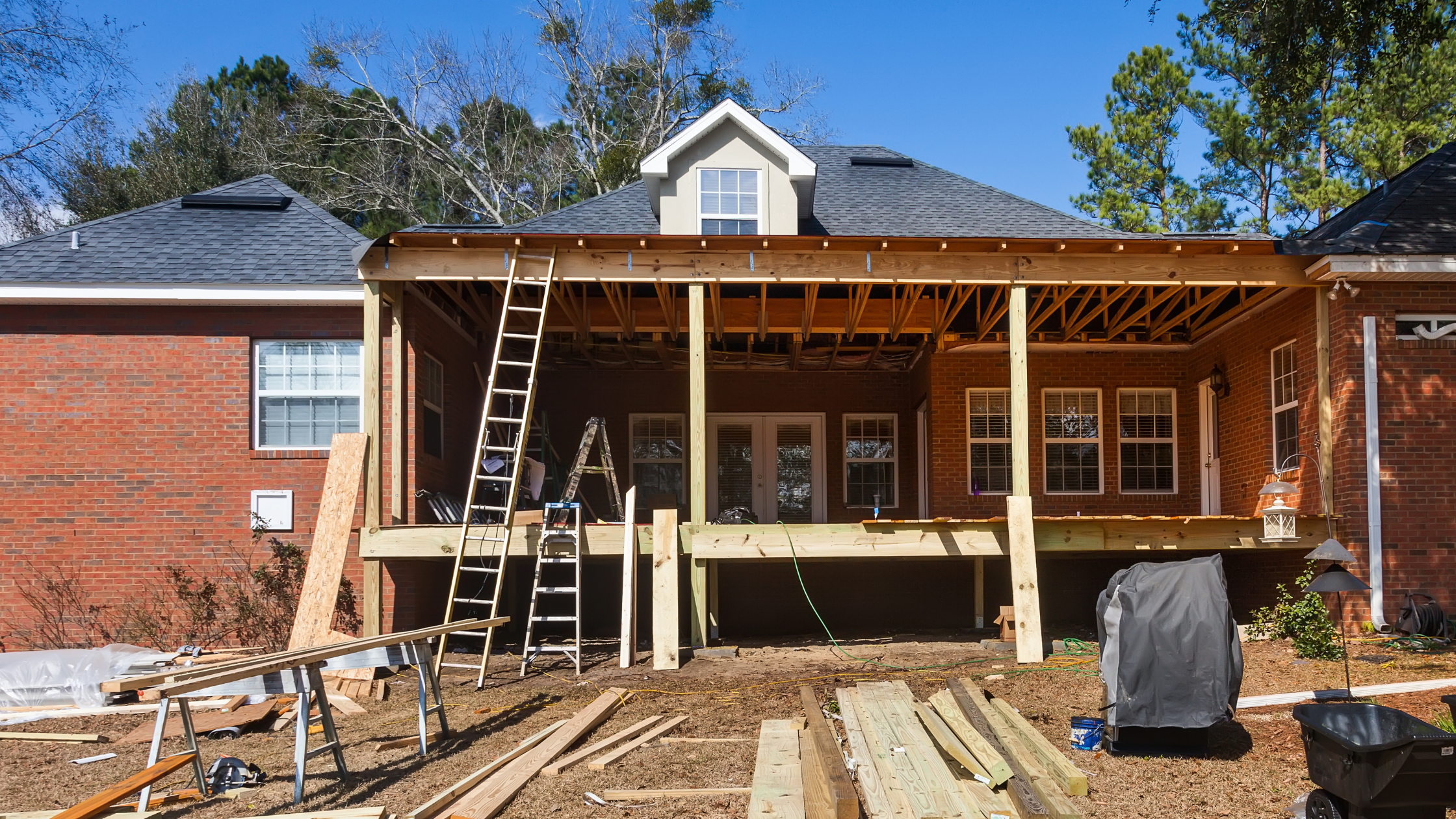 Home equity blog banner. Photo of back of house under construction with new deck installation