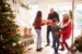 Children greeting grandparents at door for holidays