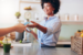 Smiling lady cashier accepting debit card for payment