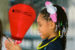 Young african american girl smiling while holding a red light the night lantern