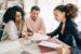 Couple sitting with financial planner reviewing papers