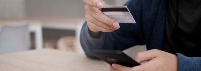 Person making purchase on mobile phone using AFFCU Power Checking Debit Card