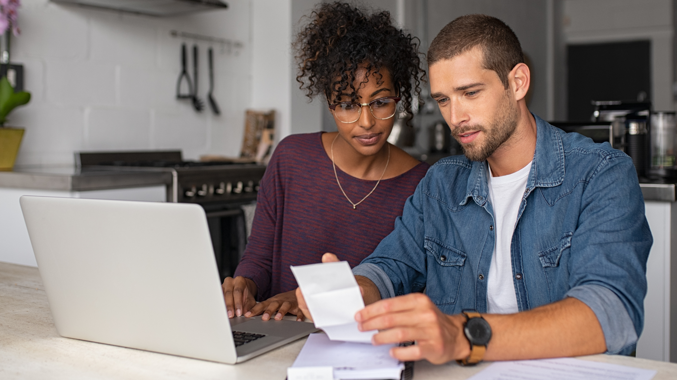 AFFCU Blog cover- young couple reviewing personal budget at laptop