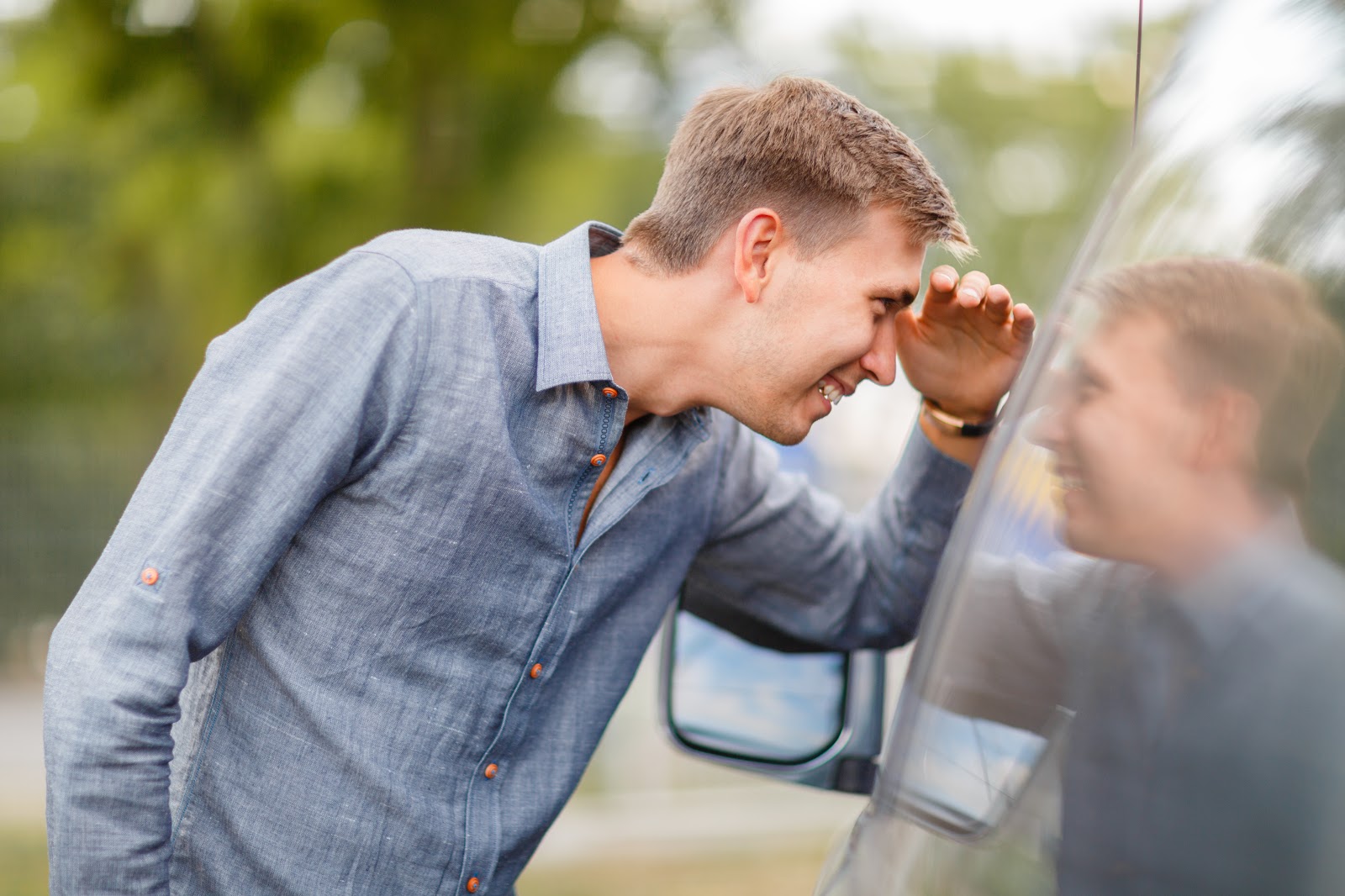 young man looking at used vehicle discovering what to know when buying a used car