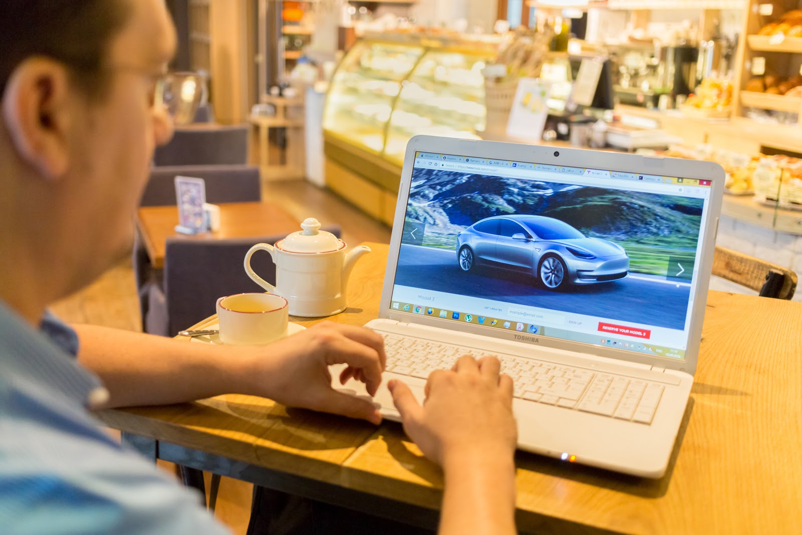 man researching where can I get a car loan on laptop computer