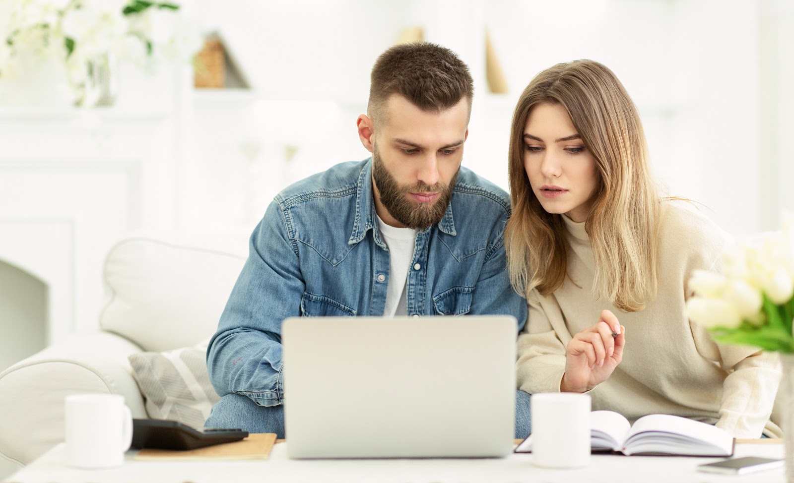 couple reading about how to open a checking account online at home computer