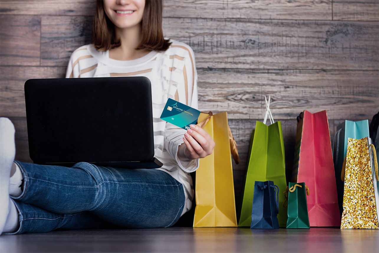 Lady sitting on floor with laptop shopping online