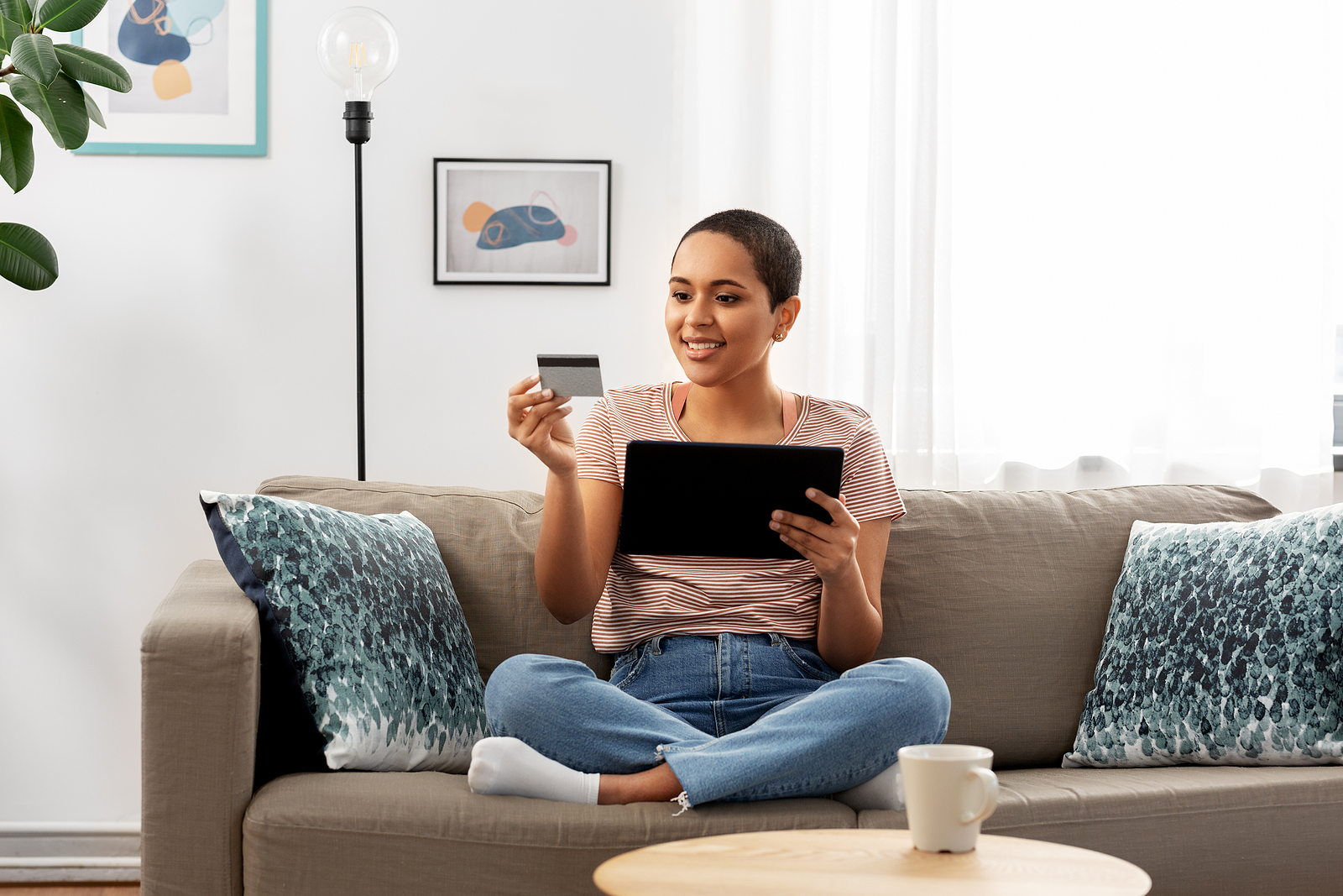 a happy woman using her checking account to shop from the convenience of her home