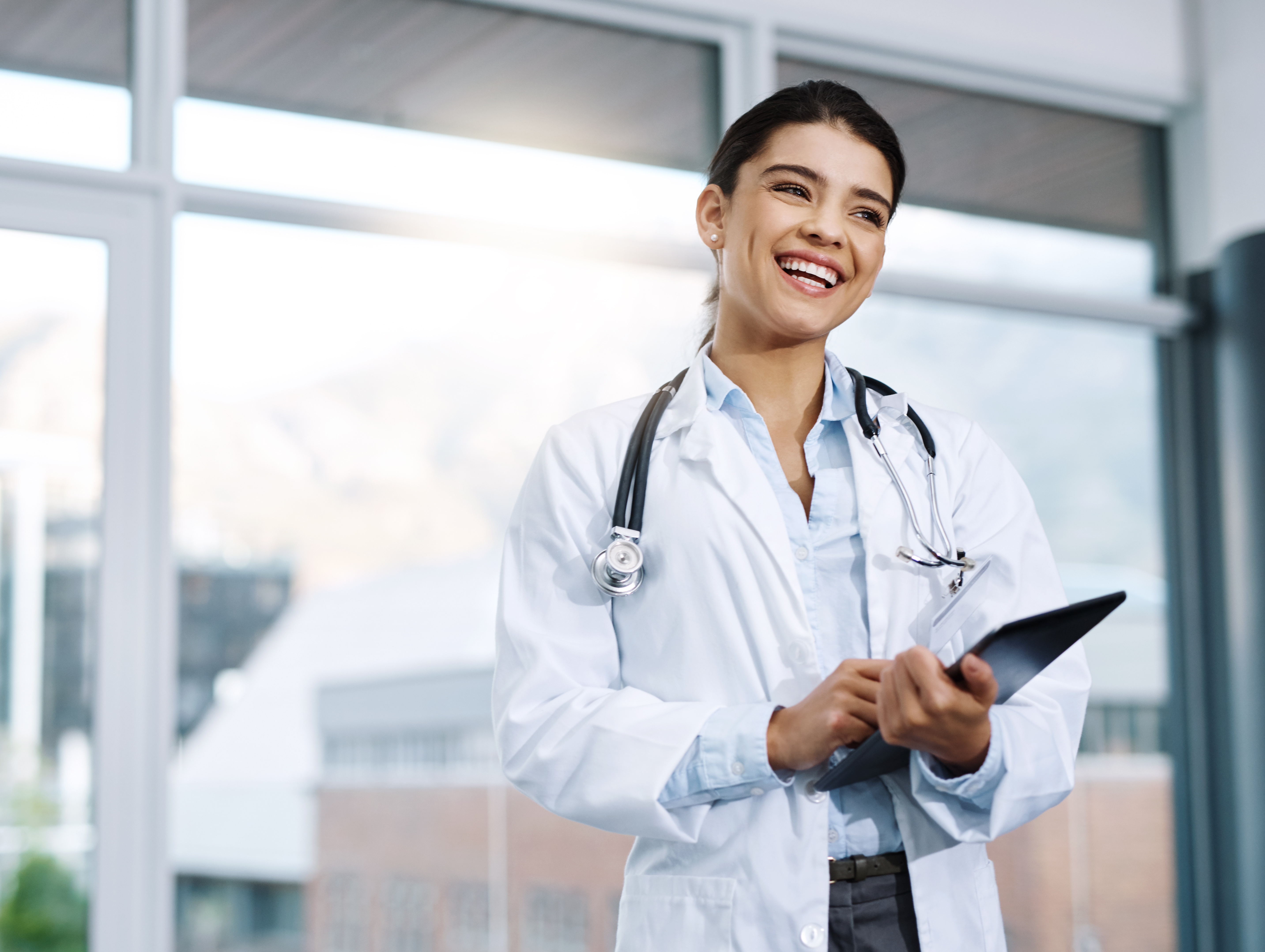 Smiling female doctor with tablet ready to meet with patient