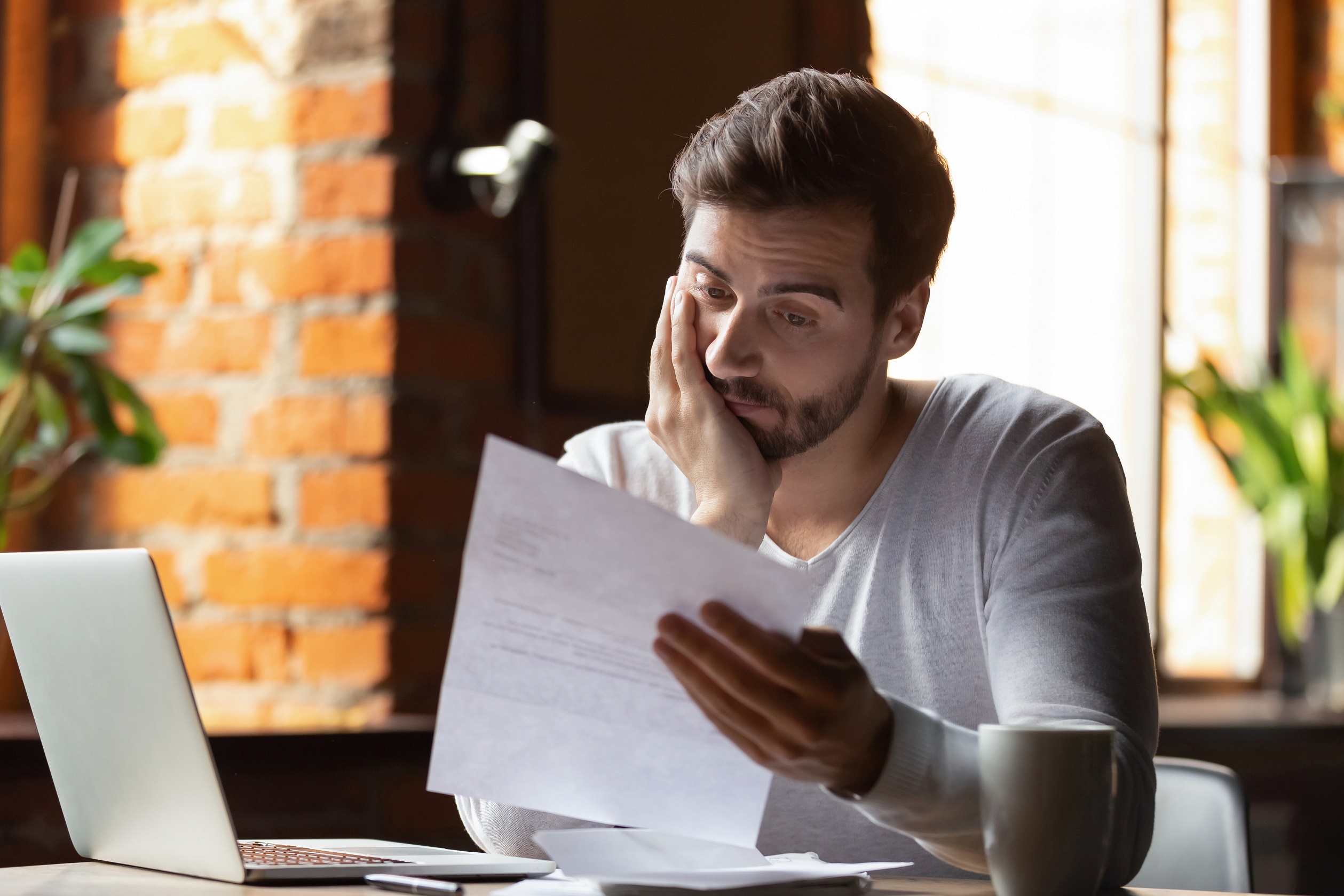 Frustrated young man readin letter