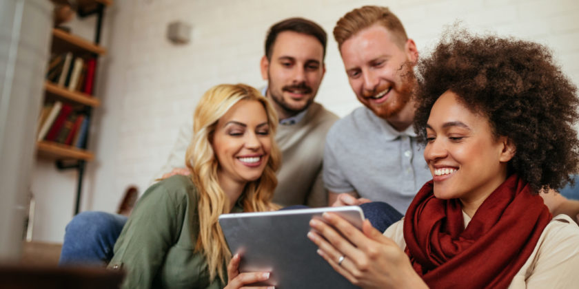 Group of friends looking a tablet