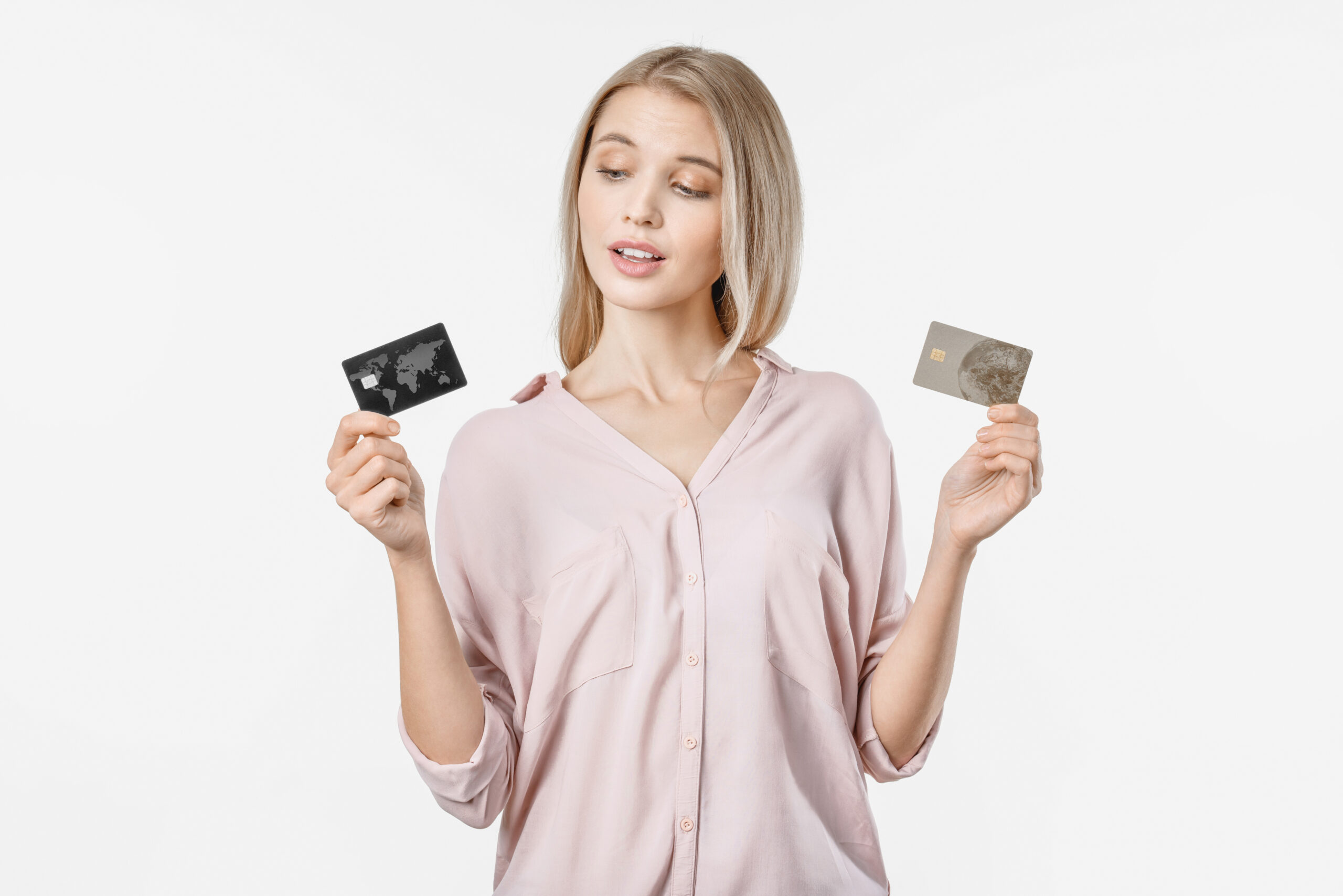 A woman looks at her credit cards and wonders if she should take out a personal loan to pay off her credit card debt.