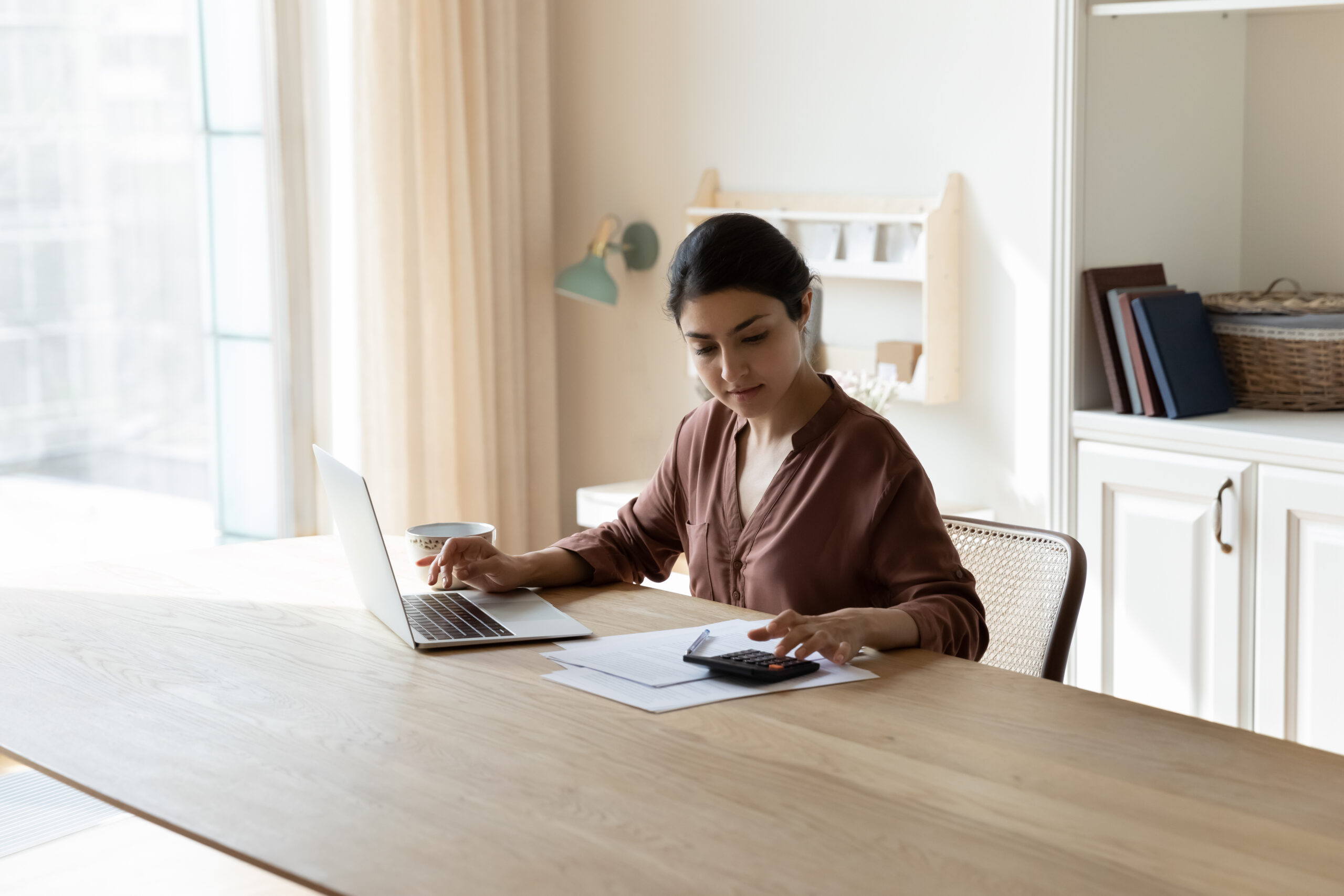 A woman calculates the value of collateral used for a personal loan.