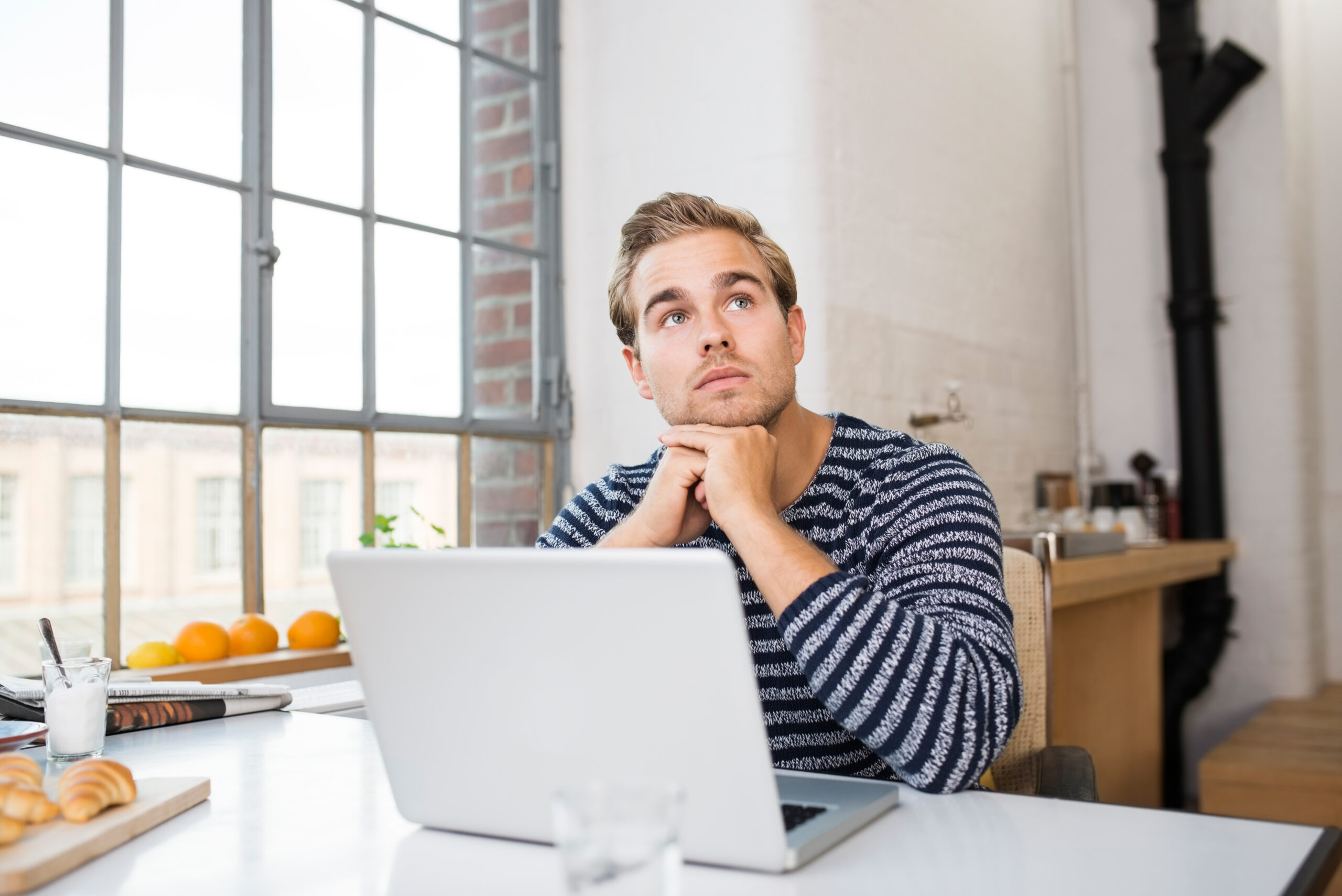 A young man considers what to use a personal loan for.